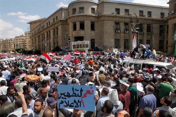 [Thousands of mostly Egyptian Muslim Brotherhood members shout slogans during a protest in front of the the Supreme Judicial Council in Cairo, Egypt, Friday, April 19, 2013. Arabic reads, \"yes to clean media.\" Thousands of supporters of Egypt`s Islamist president have taken to the streets of Cairo, calling on him to \"cleanse the judiciary.\" Mohammed Morsi and the judiciary have had tense relations since he came to power in June last year. Judges accused him of trampling on their authority, while Morsi supporters charge that the judiciary is controlled by supporters of ousted President Hosni Mubarak. (AP Photo/Amr Nabil)]