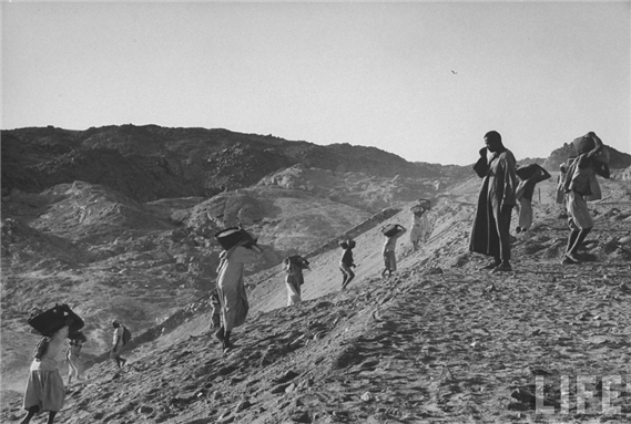 "Laborers working at the Aswan High Dam construction site.April 1960" by Kodak Agfa. Photo via Creative Commons.