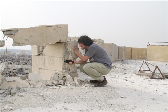 [Filmaker Bassel Shahade filming in Homs during the spring of 2012. Image from his facebook page.]