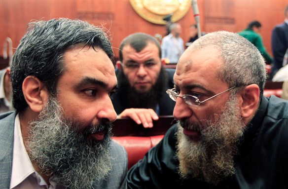 [Salafist cleric leader Yasser Borhami (right) speaks with Morsi`s presidential advisor Bassam al-Zarqa during the constitutional marathon vote in the assembly on 30 November. Image by Mohamed Abd El Gany/Reuters]