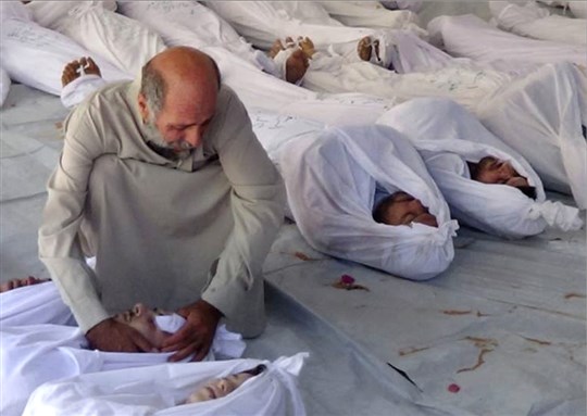 [Syrian man mourning over a dead body after an alleged poisonous gas attack fired by regime forces in Douma town, Damascus, on Wednesday 21 August 2013. Image by Associated Press / Media Office Of Douma City]