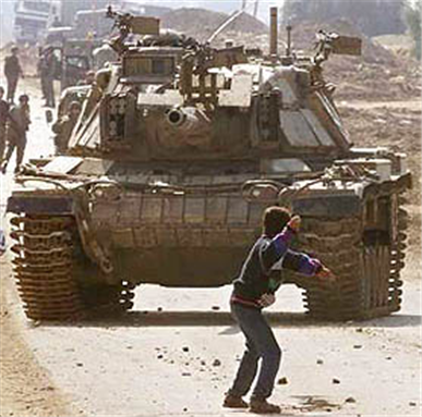 Palestinian child Faris Odeh faces down an Israeli tank during the Al-Aqsa Intifada. Photo via Wikimedia Commons.