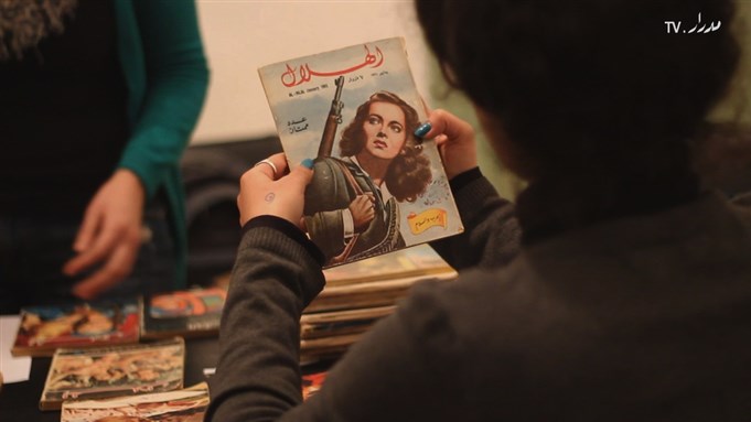 [A participant studies a copy of al-Hilal magazine during a workshop led by Marwa Arsanios. Image courtesy of Medrar TV.]