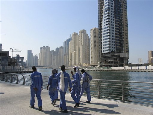 [Construction workers in Dubai. Image from Wikimedia Commons.]