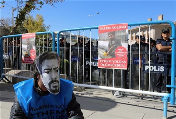 [A protester wears a mask with an image of Ethem Sarisuluk as the trial against the policeman accused of killing him starts in Ankara, 23 September 2013. The placard reads: \"Ethem is immortal.\" Photo by Burhan Ozbilici/AP Photo.]
