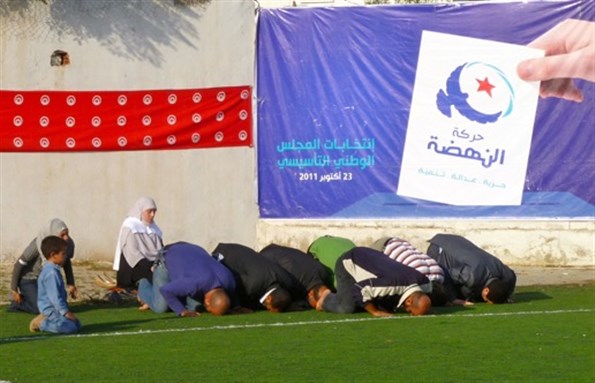 [Attendees at an Ennahda political rally pause for prayer. Image by Emily Parker.]