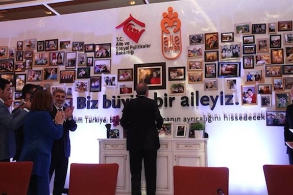 [Prime Minister Erdogan looking at his family photos, 18 June 2013. Photo by Harun Sari-Mesut Yesil, via the Ministry of the Family and Social Policy’s Facebook Page]