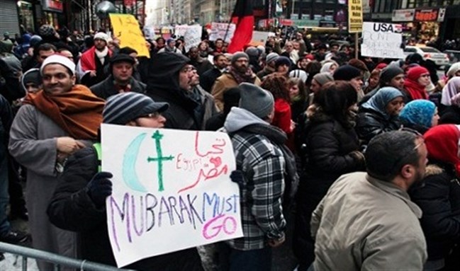 [Egyptians living in the US support January revolution in New York`s Times Square last winter. Image from Reuters.]