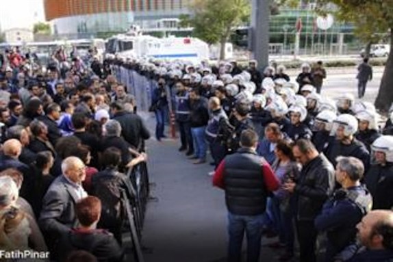[People facing police barricades during commemorations of the massacre in Ankara. Image by Fatih Pinar.]