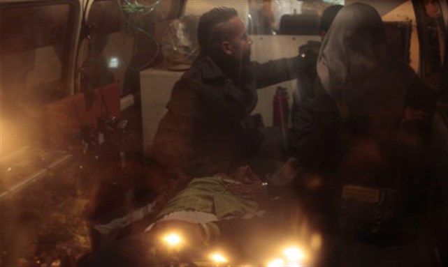 [People attend to a protester who had fell sick while taking part in a sit-in protest against the government outside the cabinet headquarters, in an ambulance near Tahrir Square in Cairo, 14 December 2011. Image from Reuters.]