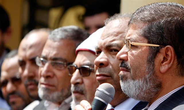 [Far right: Mohamed Mursi, head of the Muslim Brotherhood`s Freedom and Justice Party (FJP). Image from Reuters]