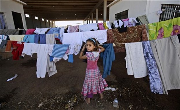 [A Syrian girl who fled her home with her family due to fighting between the Syrian army and the rebels. AP Photo/Muhammed Muheisen]