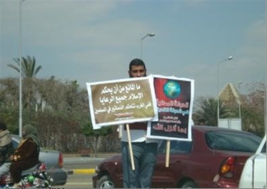 [Egyptian activist carrying signs that read “The civil state is an atheist state.” (right) “What is the problem with Islam governing all nationals? In the West constitutions rule over Muslims.” (left) Image from author`s archive]