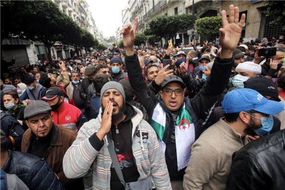 Demonstrators shout slogans as they march to mark the second anniversary of a mass protest movement demanding political change via Reuters by Ramzi Boudina