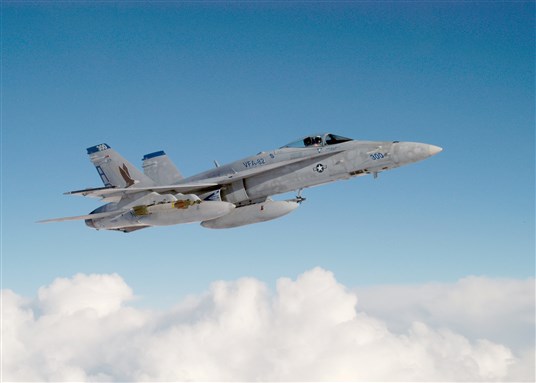 [An U.S. Navy F/A 18 Hornet on duty over the Northern Arabian Sea. Image from U.S. Navy. Photo by Lieutenant Perry Solomon.]