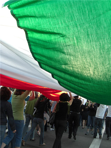 Iranian Flag in Green Movement Demonstration (via Wikimedia Commons)
