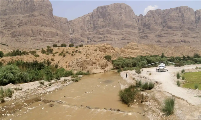 A rescue helicopter positioned on the bank of a river, after flooding caused by heavy rainfall in southern Iran's Estahban county. Photograph: Mohammad Ali Mohammadi/AFP/Getty Images