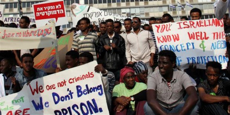[Protest against migrant detention facilities. Image from amnesty.org]