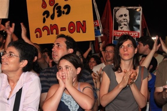 [Poster with Netanyahu image: \"Bibi go home.\" Yellow poster: \"Gasoline tariff = mas-khara.\" Image from beforeitsnews.com]