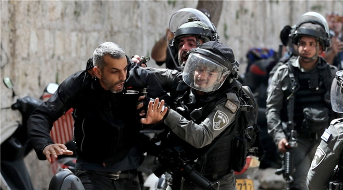 Israeli police detain a Palestinian man during clashes at the compound that houses the al-Aqsa Mosque in Jerusalem on Monday via Reuters by Ammar Awad
