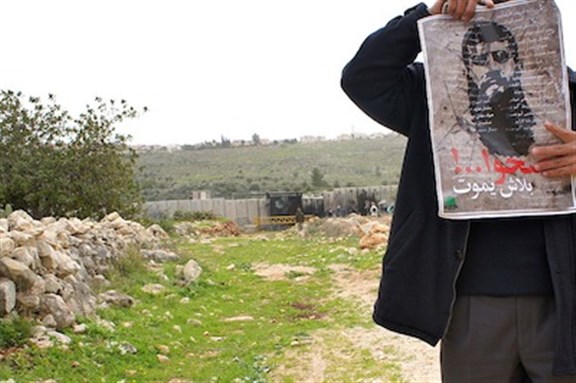 [Protester marching in support of Khader Adnan in Ni`ilin, West Bank,17 February 2012. Image by Friends123]