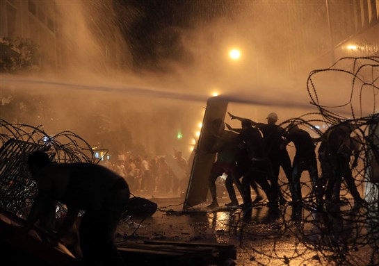 [Protestors Clashing With Police: Image from AP]