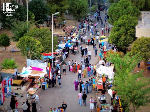[A market for displaced Syrians in the Aleppo university dormitories. 3 October 2012. Via Lens of a Young Halabi.]