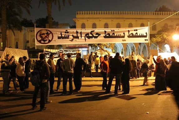 [\"Down with the rule of the [Muslim Brotherhood General] Guide,\" reads a sign by the Presidential Palace on 31 December 2012. Photo by Gigi Ibrahim]