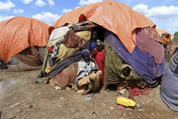 A mother and her children outside their makeshift shelter in Raama Cadeey IDP camp in Baidoa, Somalia. © UN Photo / Fardosa Hussein