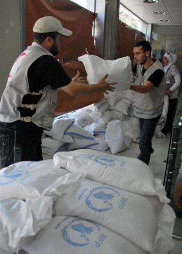 [Syrian ?Arab Red Crescent workers organize supplies and aid in Damascus. 1 August 2012. Via Syrian Arab Red Crescent.]