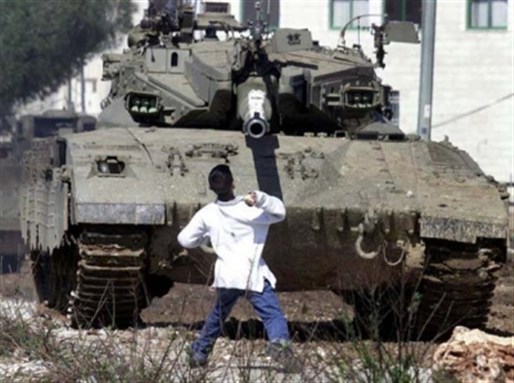 Faris Odeh facing down Israeli tanks during the Al-Aqsa Intifada (29 August 2000). Photo via Flikr.