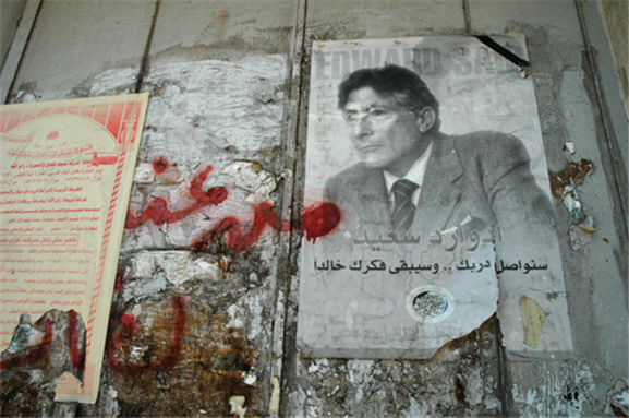 Graffiti of Edward Said on the wall in Ramallah (2004). Photo by Justin McIntosh via Wikimedia Commons.
