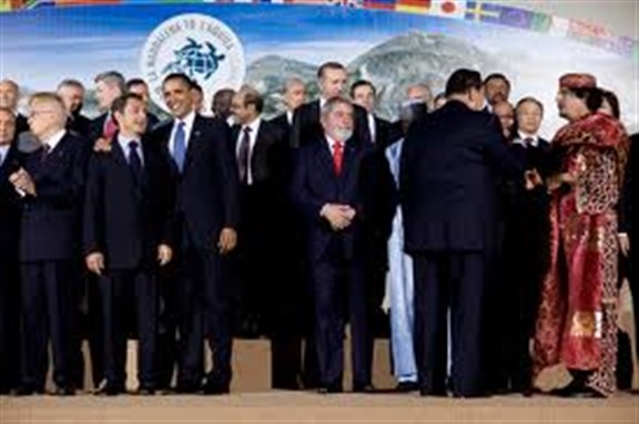 [Former French President Nicolas Sarkozy visited Libya this week. In 2009 he and Gaddafi posed for a `family photo` at the G8 summit in L`Aquila. Photo from Wikimedia Commons..]