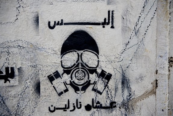 [Graffiti on Mohamed Mahmoud Street. \"Put this on because we`re going out.\" Photo by Hossam el-Hamalawy]