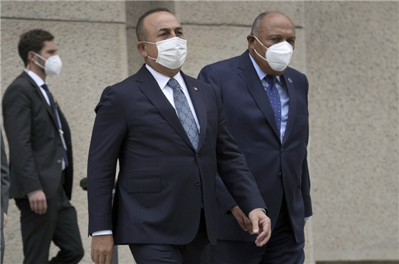 Turkish Foreign Minister Mevlüt Çavuşoğlu (L) and his counterpart from Egypt, Sameh Shoukry (R), arrive for a group photo during the "Second Berlin Conference on Libya" at the foreign office in Berlin, Germany, June 23, 2021 via the Associated Press