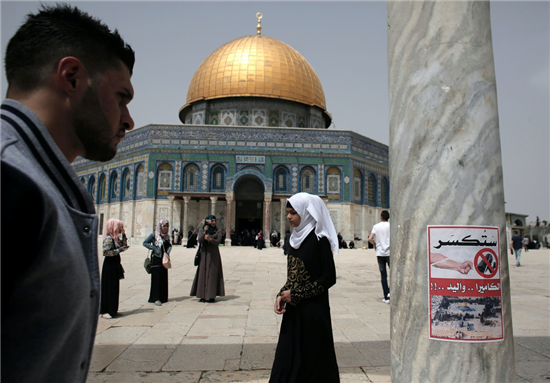 A poster calling for the destruction of CCTV cameras is posted on a column at the Al-Aqsa Mosque compound in Jerusalem in front of the Dome of the Rock, April 8, 2016 via AFP/Getty Images from Ahmad Gharabli