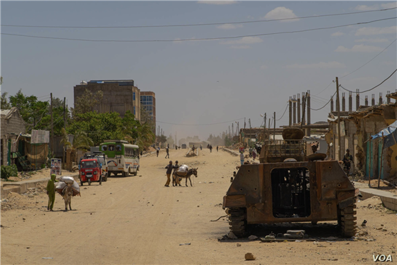 A destroyed armored vehicle lays in one of the mains streets of Hawzen, a small town in the frontline of the war in Tigray, Ethiopia, on June 6, 2021 via VOA by Yan Boechat