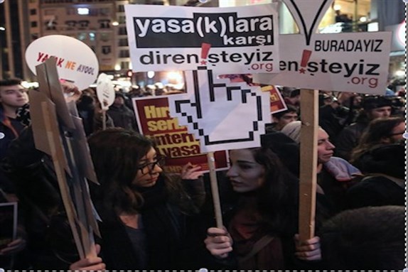 [People hold a banner that reads “we resist against bans” as they protest against Internet restrictions in Istanbul. Media reports say close to eighty thousand people have stopped following Turkey`s president Abdullah Gül on Twitter after he signed a controversial bill increasing government controls over the Internet into law on 19 February. (AP Photo/Emrah Gurel, File)]