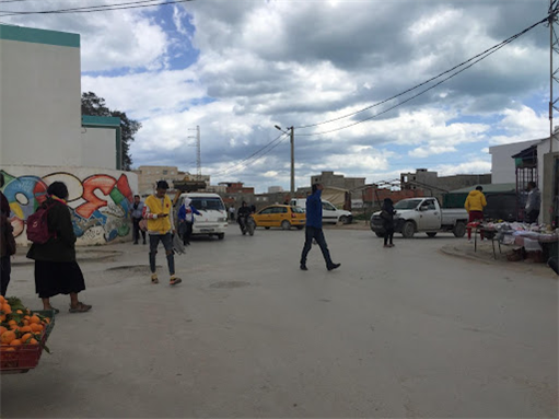 The main crossroad in Bhar Lazreg. The primary school building is to the left, the vegetable and second-hand clothing market is to the right, and Rue Charles de Gaulle is straight ahead. Photo by Molka Ghorbel, March 2022.