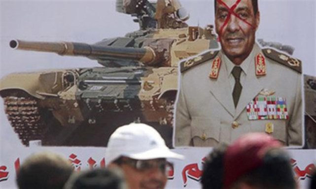 [Bottom of banner reads \"Unite before the military tanks step on you.\" Image from Reuters]