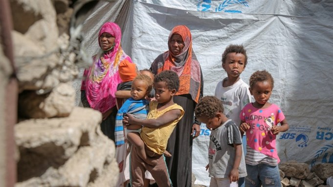 Displaced Yemeni mother, Gabra (in pink) and her family, in a hosting site in Sana’a via UNHCR/Ahmed Haleen