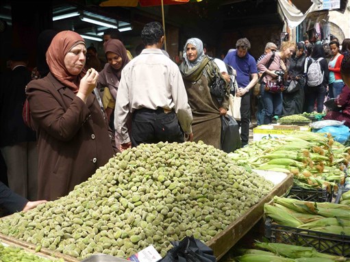 [Palestinians and Guests of the Palestine Festival of Literature at the Local Market in Al-Khalil. Image by Taline Voskeritchian]